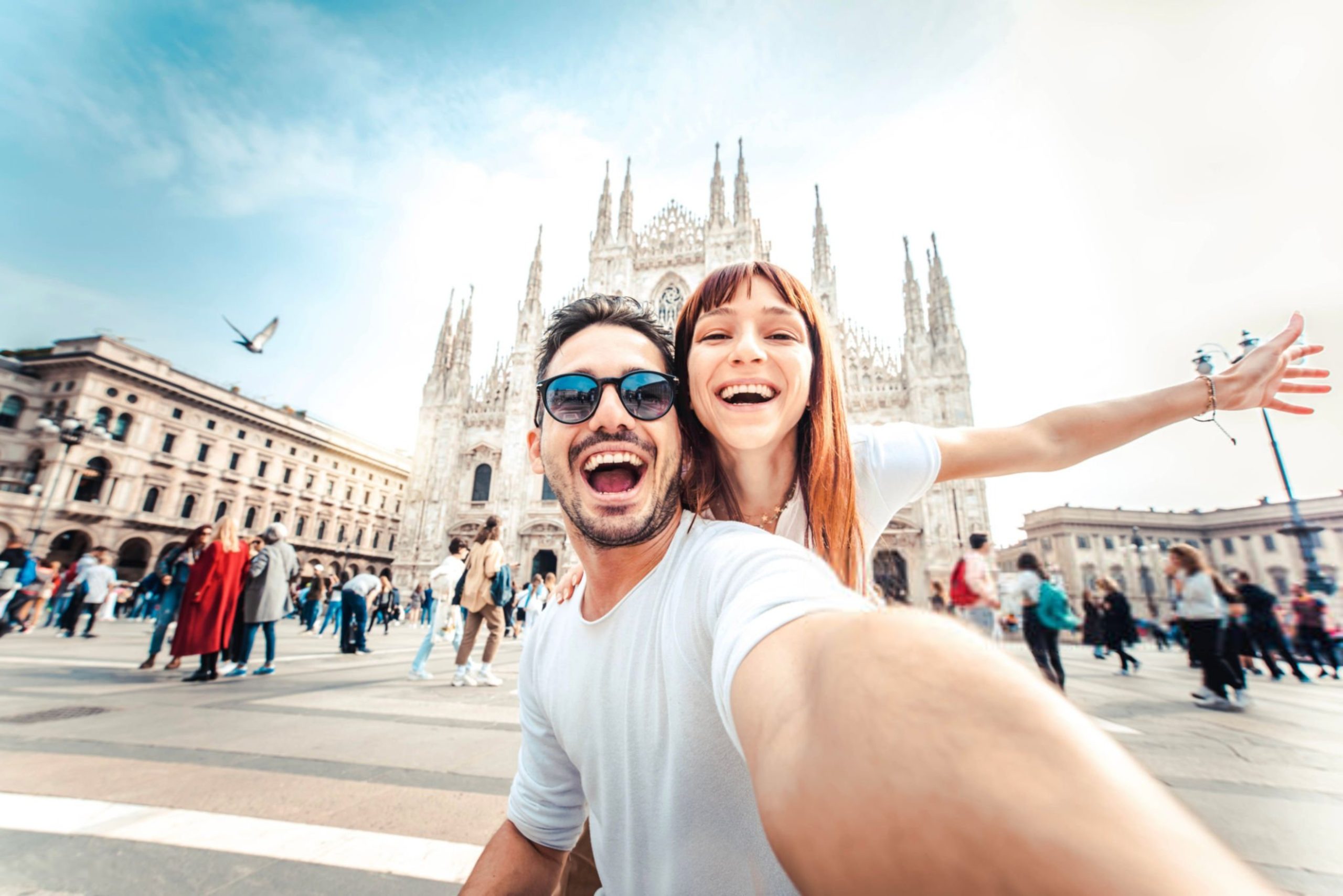 Happy couple taking selfie in front of Duomo cathedral in Mi (1)